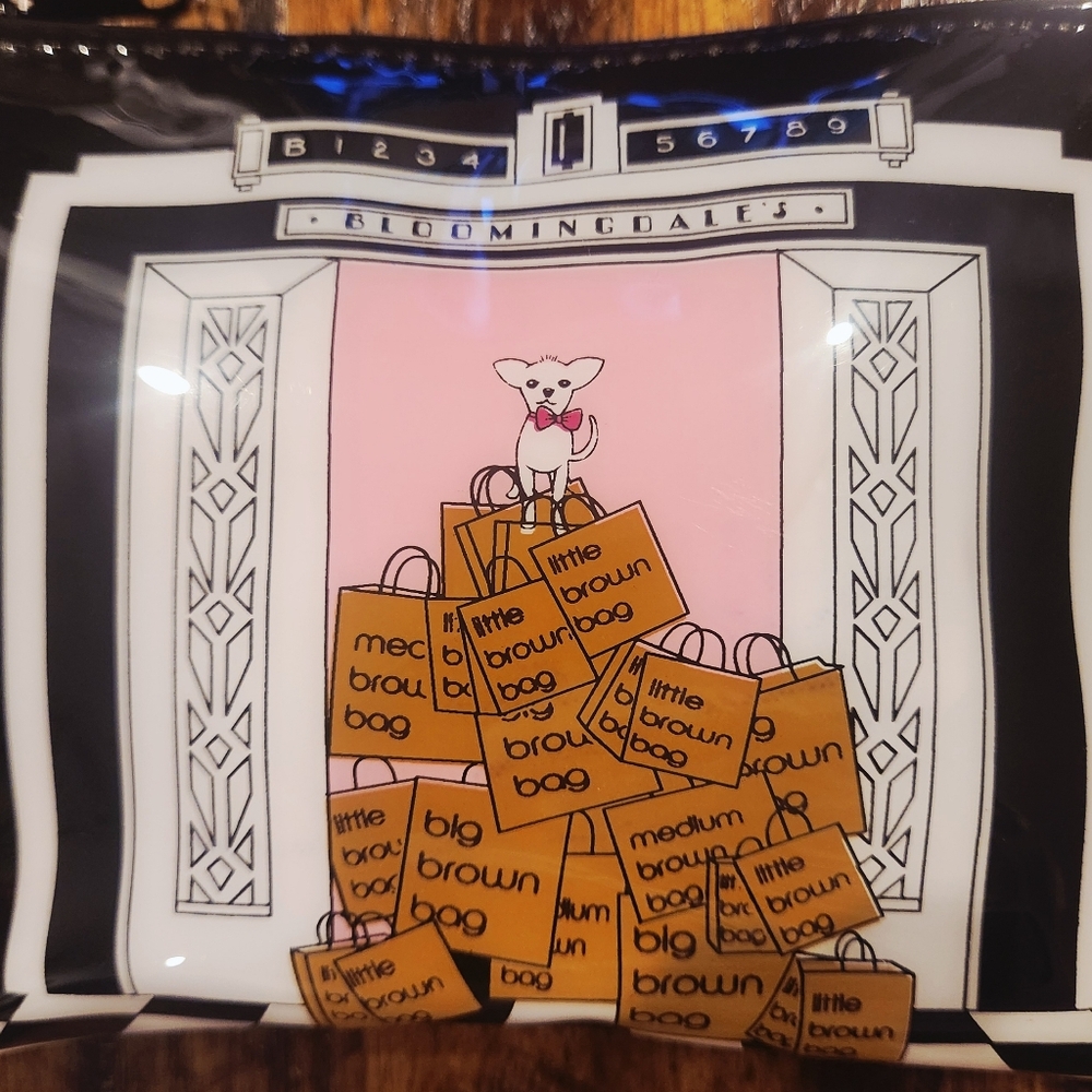 Bloomingdale's cosmetic case featuring the iconic "dog elevator" graphic design.